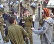 A street performance on the streets of Jerusalem show civilians and soldiers alike dancing to the Black Eyed Peas