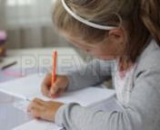 Get 100&#39;s of FREE Video Templates, Music, Footage and More at Motion Array: http://bit.ly/2SITwWM nnnGet this here: https://motionarray.com/stock-video/school-girl-does-homework-177792nnSchool Girl Does Homework is an amazing stock video that displays a close-up shot of a cute school girl doing her homework while sitting at a table at home. This 1920x1080 (HD) bit of footage will look awesome in any video project that has to do with education, schools, children, etc. Download this video today, a