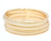 https://www.ross-simons.com/869467.htmlnnSlip on this stack of seven textured bangles for a full-on fashion statement! Textured and brushed, these 18kt yellow gold over sterling silver bracelets make a statement, and are so easy to wear! They will instantly become your go-to choice for arm candy. Made in Italy. The four textured bangles measure approx. 1/6