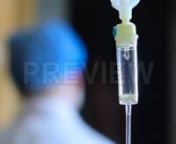 Get 100&#39;s of FREE Video Templates, Music, Footage and More at Motion Array: https://www.bit.ly/2UymF81nGet this here: https://motionarray.com/stock-video/iv-drip-intravenous-therapy-71213nnThis stock video features a closeup of an IV Intravenous drip mechanism. A clear liquid continuously drips into a plastic tube to administer liquid substances directly into a patient&#39;s vein. The depth of field is shallow, and a doctor wearing scrubs walks through the background. This clip is perfect for projec