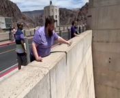 In this fascinating video, a man attempts to throwwater down a dam, expecting it to plummet to the depths below. However, the strong updraft from the dam prevents the water from descending as anticipated. Instead, the water appears to defy gravity, floating eerily in mid-air before eventually dispersing. This unexpected phenomenon captivates viewers with its surreal and mesmerizing display. The video showcases the intriguing interplay between natural forces and human actions.&#60;br/&#62;Location: Las Vegas, USA&#60;br/&#62;WooGlobe Ref : WGA341172&#60;br/&#62;For licensing and to use this video, please email licensing@wooglobe.com